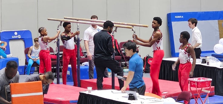 Coach James Jones with his gymnastics team.